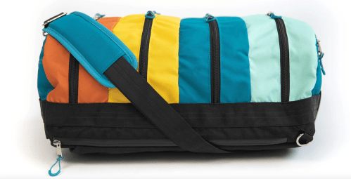 A colorful duffel bag with orange, yellow, teal, and black stripes, featuring multiple zippered compartments and a shoulder strap.